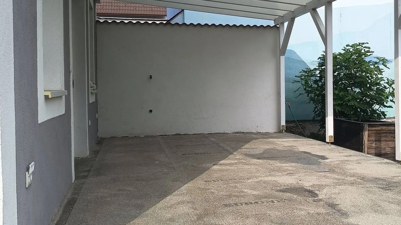 A fedett terasz régi, foltos betonja